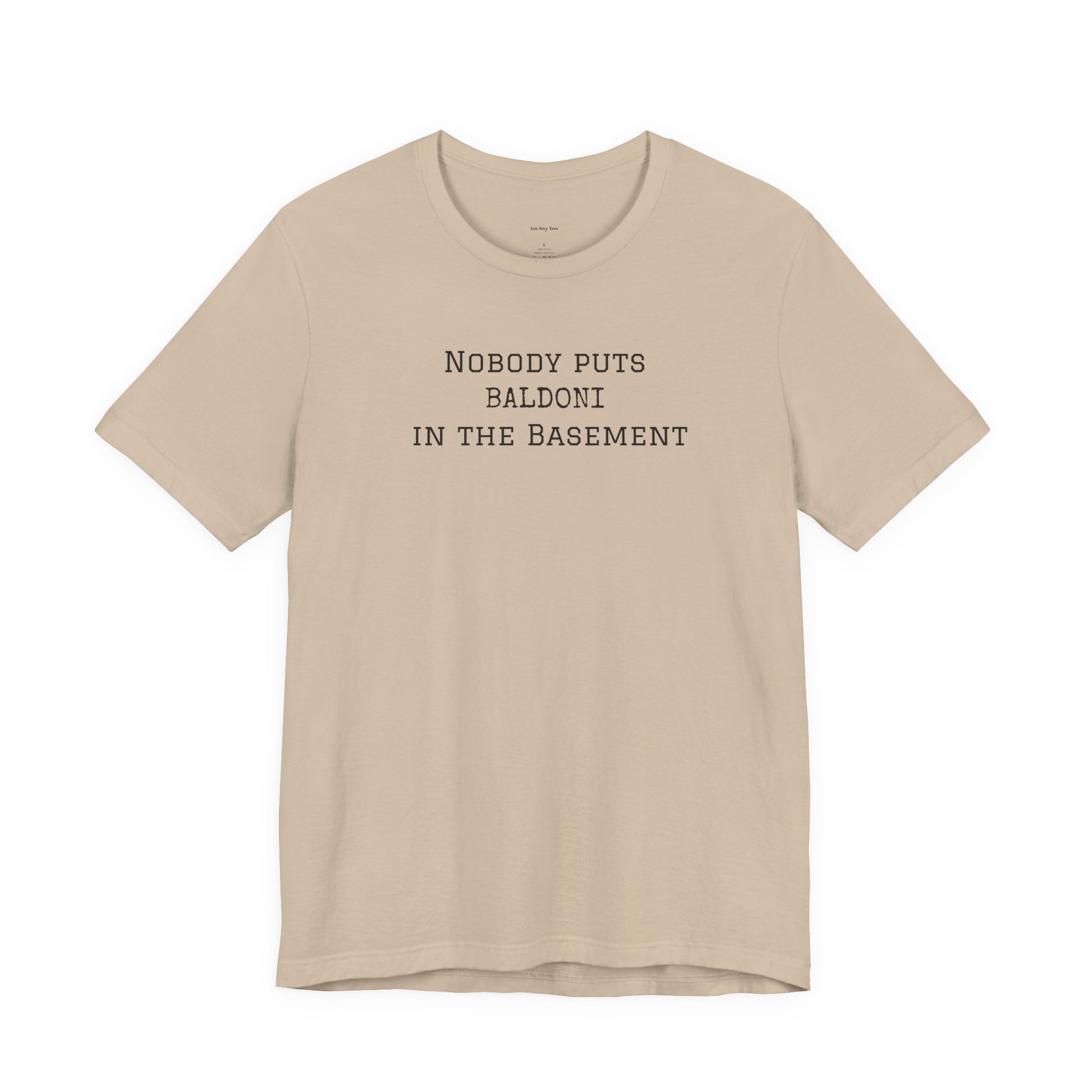 Beige t-shirt with text 'Nobody puts Baldoni in the basement'