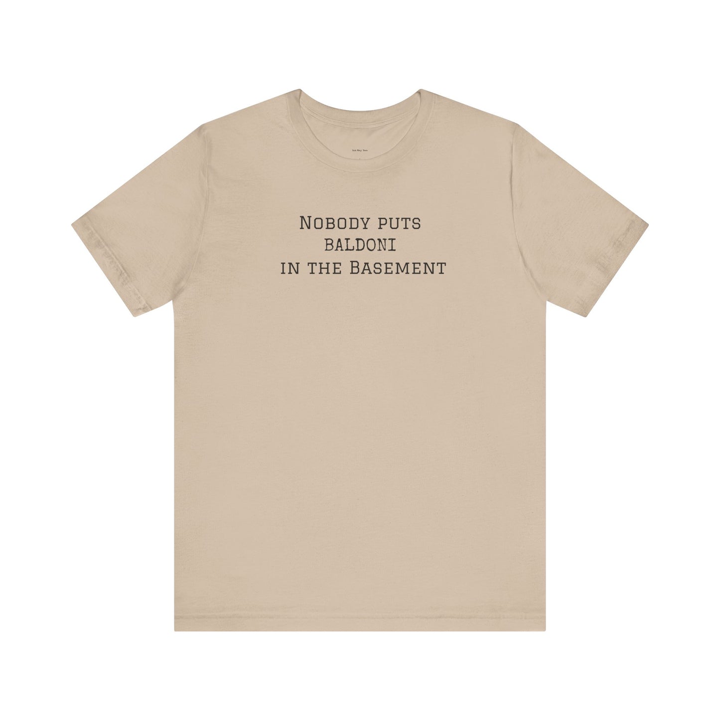 Beige t-shirt with text 'Nobody puts Baldoni in the basement'