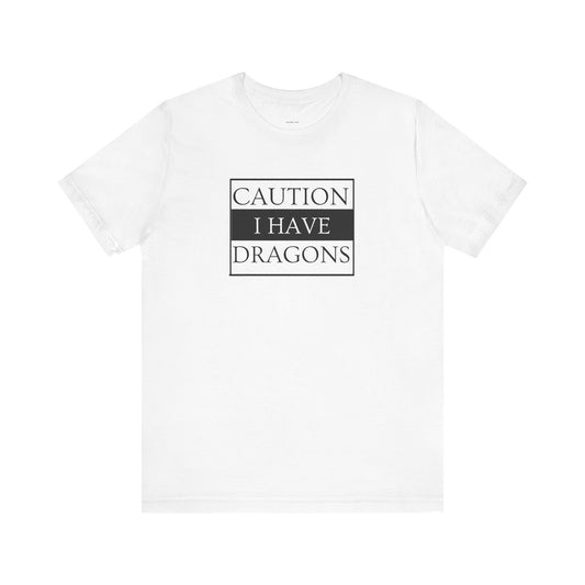 White t-shirt with 'Caution I Have Dragons' text