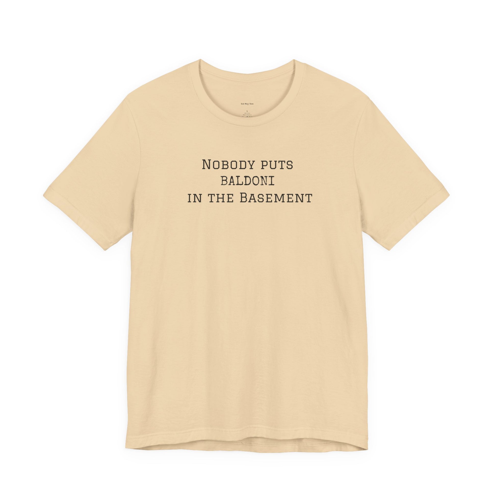 Beige t-shirt with text 'Nobody puts Baldoni in the basement'  