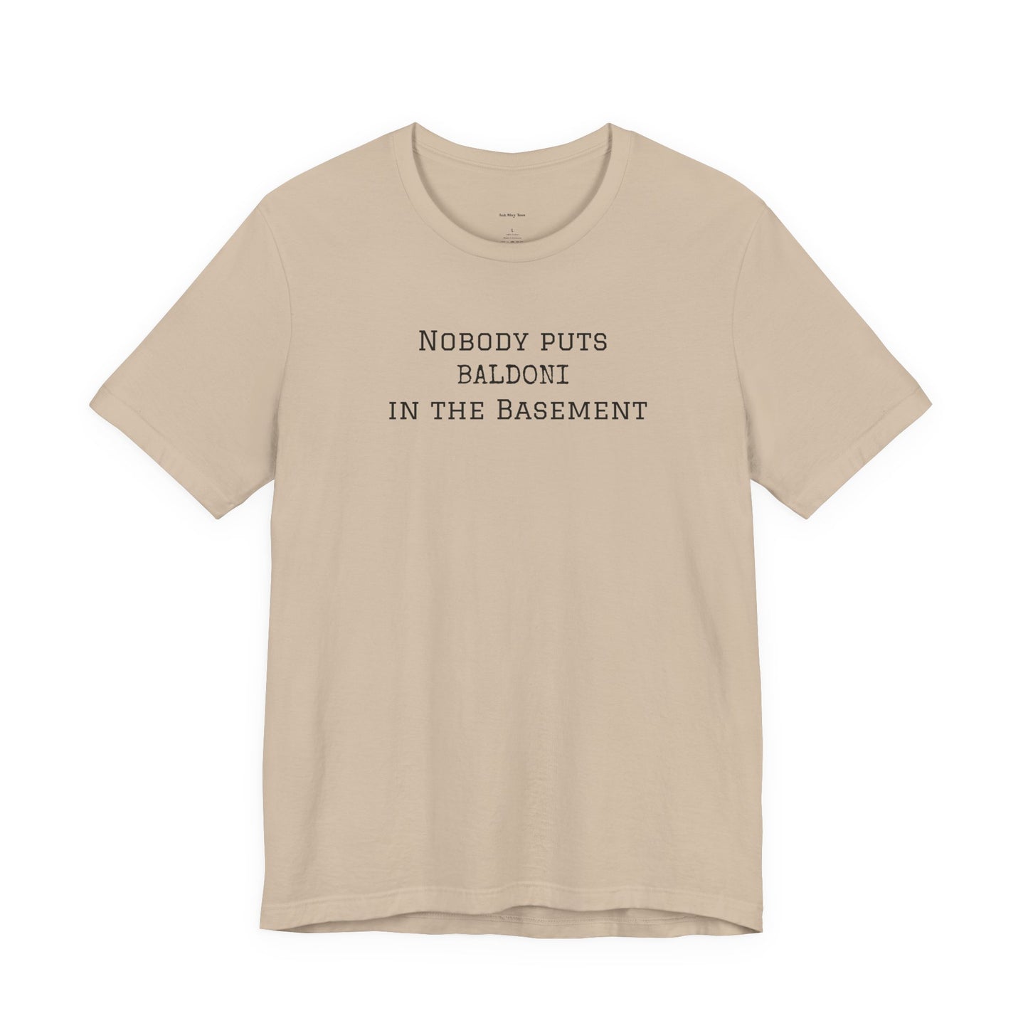 Beige t-shirt with text 'Nobody puts Baldoni in the basement'  
