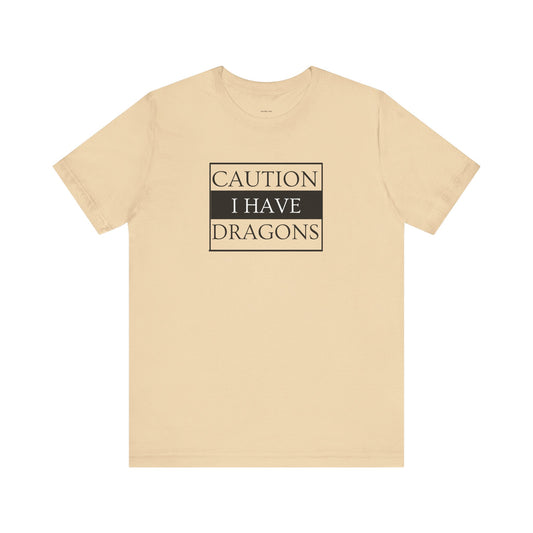 Beige t-shirt with 'Caution: I have dragons' text  