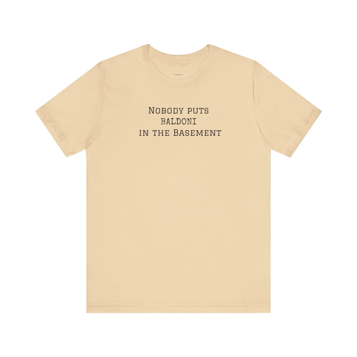Beige t-shirt with text 'Nobody puts Baldoni in the basement'  
