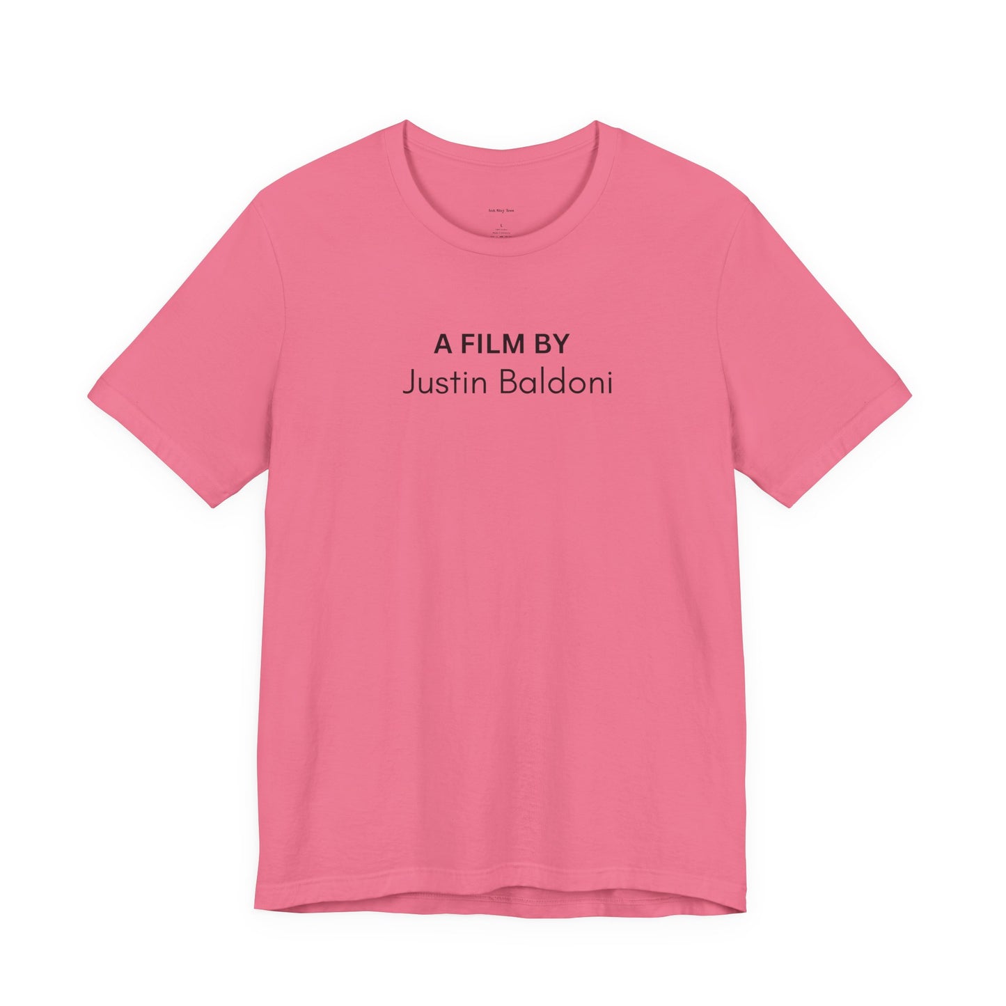 Pink t-shirt with 'A Film by Justin Baldoni' text  